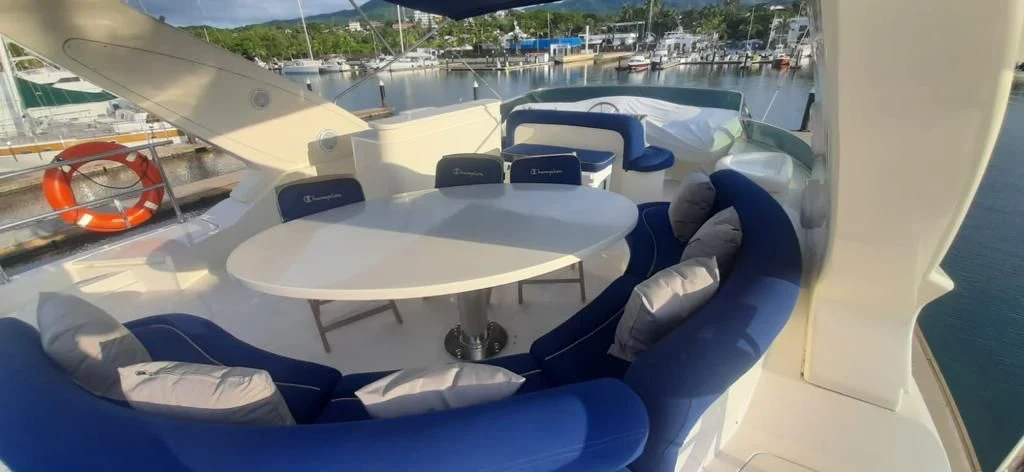 Shaded upper-deck dining area aboard the Azimut yacht