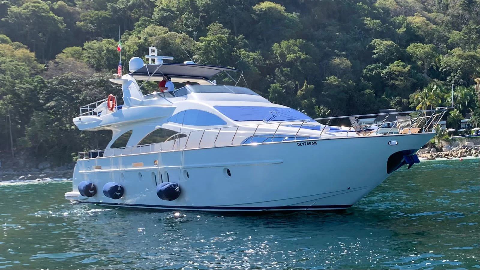 Azimut yacht anchored beside the forested Pacific coastline