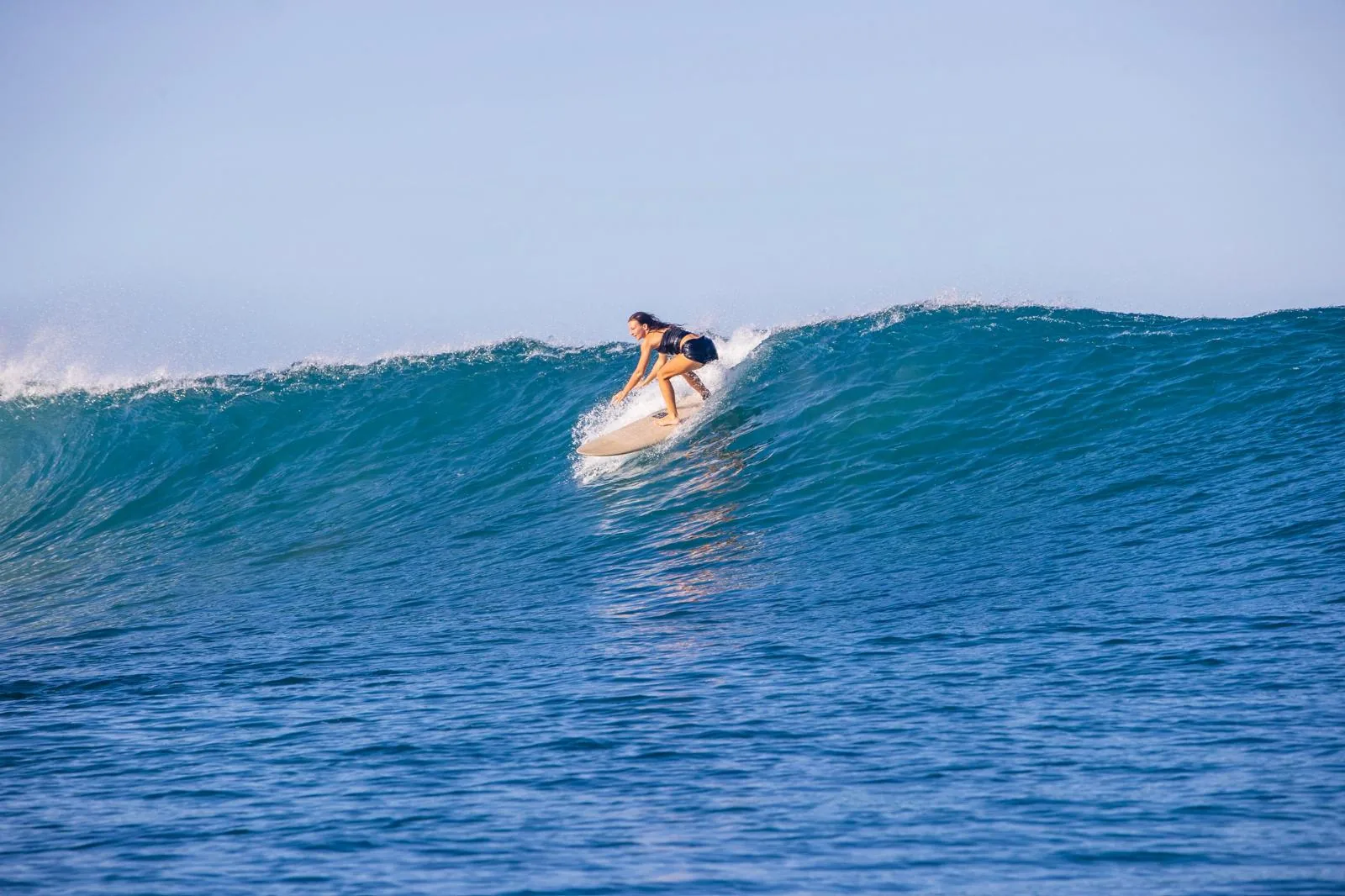 Surfer riding a long right-hand wave at Punta de Mita