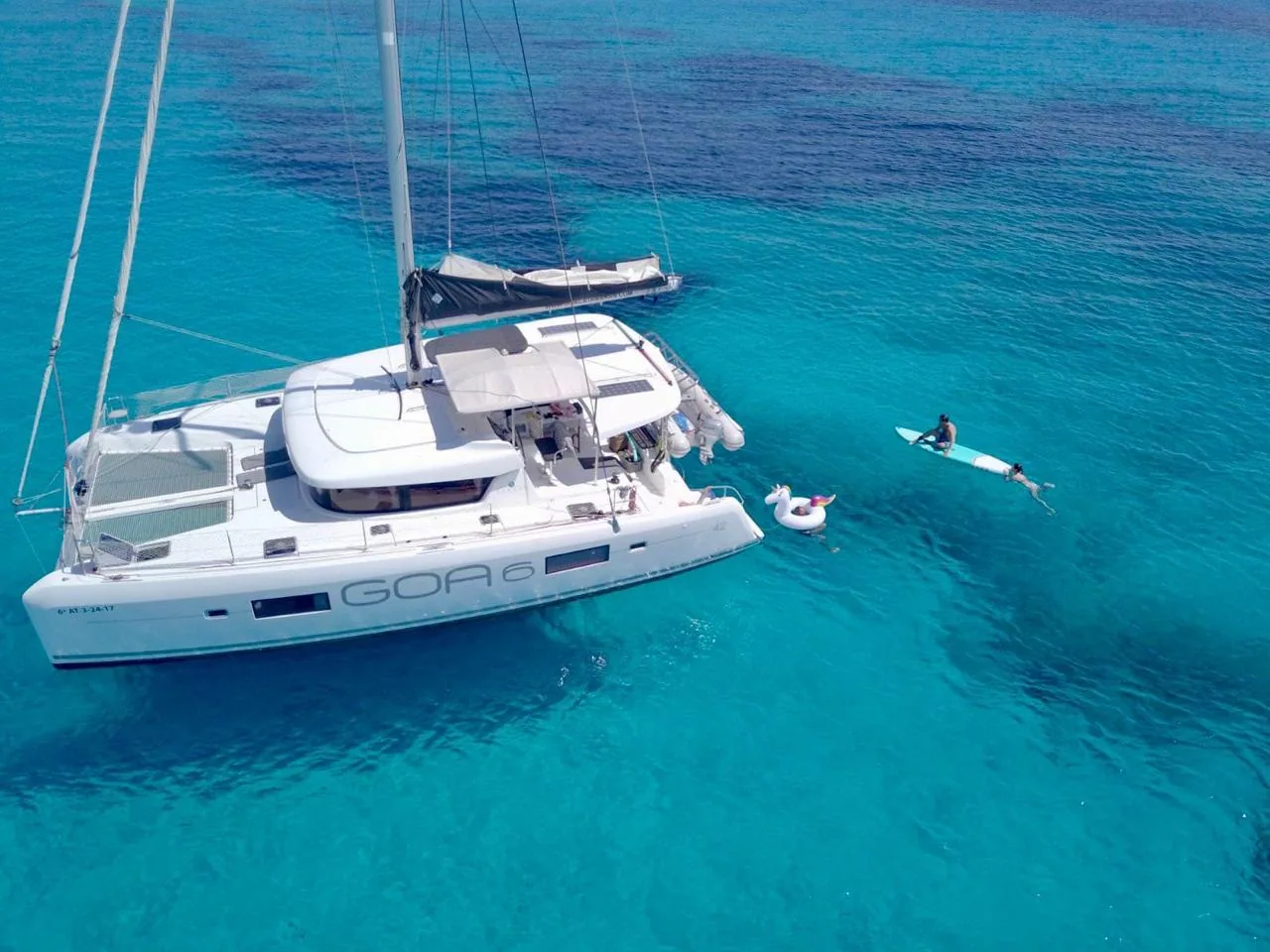 Guests relaxing on the catamaran's foredeck