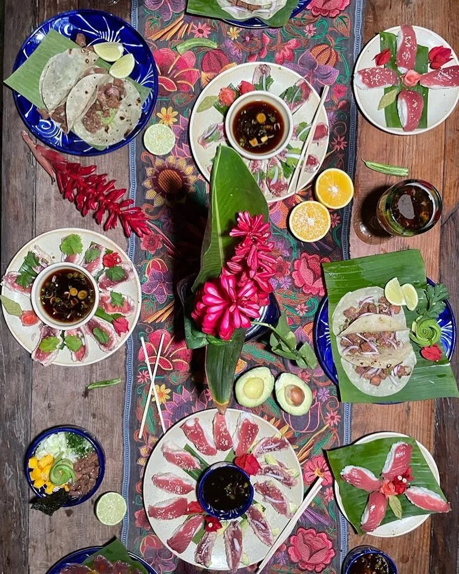 Day's catch served on a decorated table — sashimi, tacos and ceviche