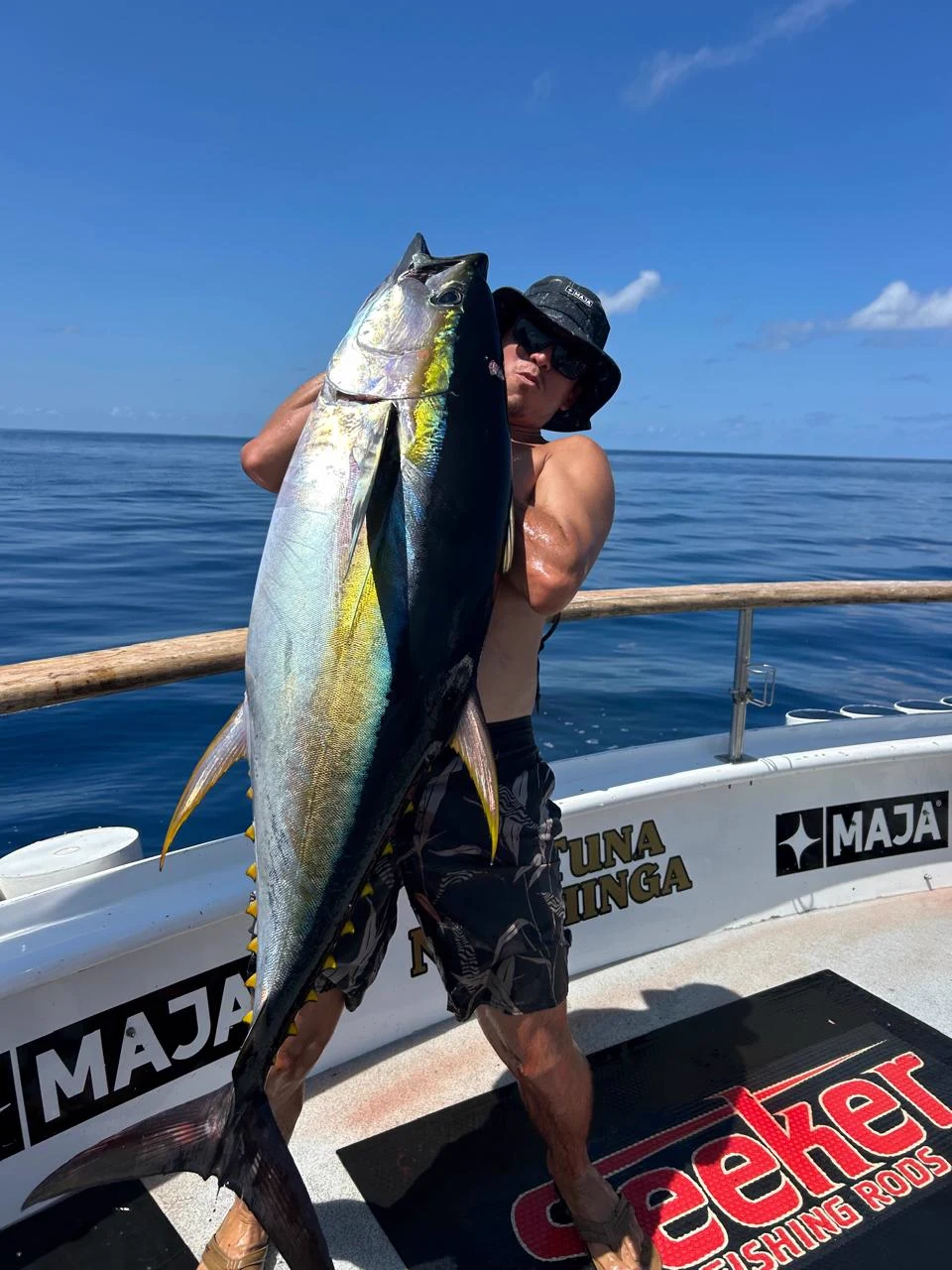 Alexis Guerrero holding a yellowfin tuna aboard the boat in Bahía de Banderas